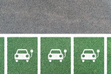Parking for electric cars only with symbols. Electric vehicle charging station with electric plug icon.. Electric vehicle charging station with electric plug icon. Copy space