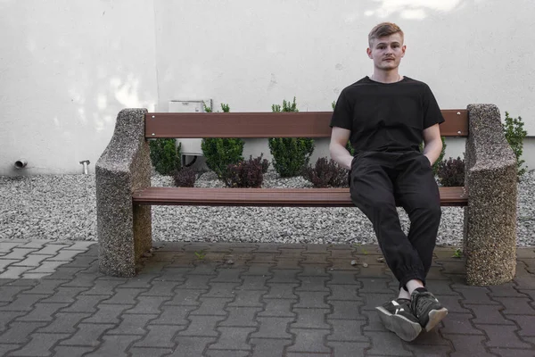 Alone Blond Caucasian Man Black Clothes Sitting Bench City Park — Stock Photo, Image