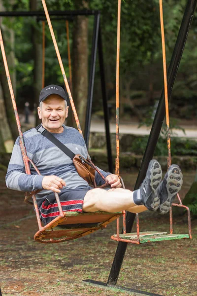 Carefree Senior Man Casual Clothes Black Cap Having Fun Swinging — Fotografia de Stock