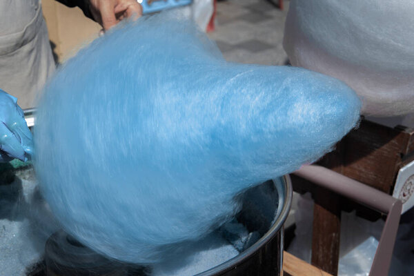 Cooking cotton candy in a special car outside. Close-up