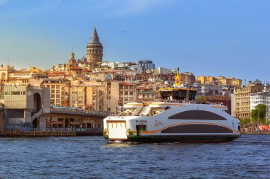 Istanbul, Turkey - April 29, 2022. Passenger ship goes against the backdrop of the old district of Istanbul - Karaky and the Galata Tower 