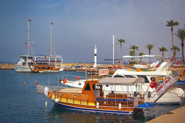 Side, Turkey - May 4, 2022. Pleasure tourist boats stand in the harbor against the sky on a sunny day