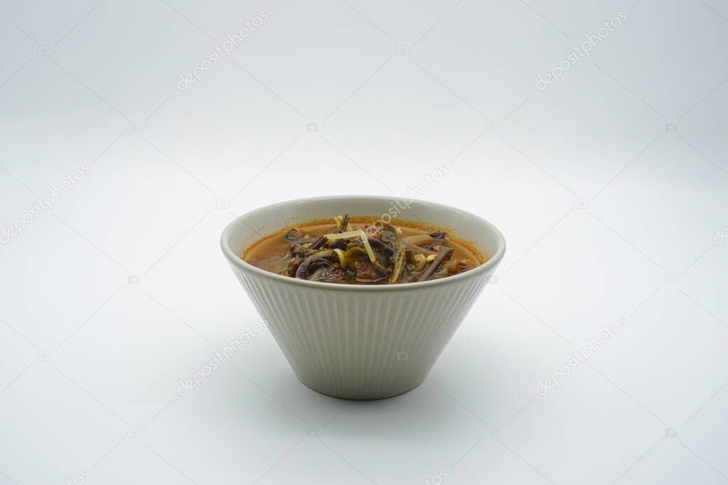 Beef Yukgaejang in a bowl on a white background