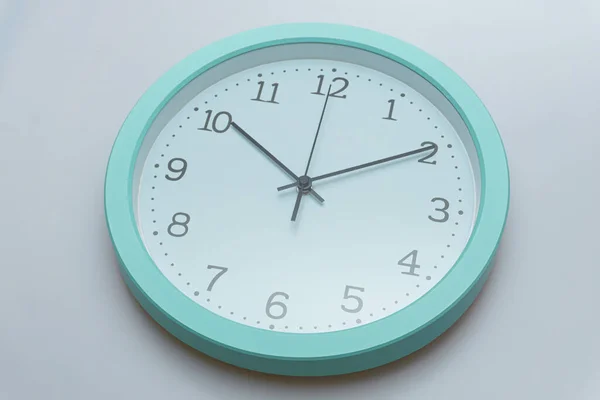 Wall clock showing various times on a white background