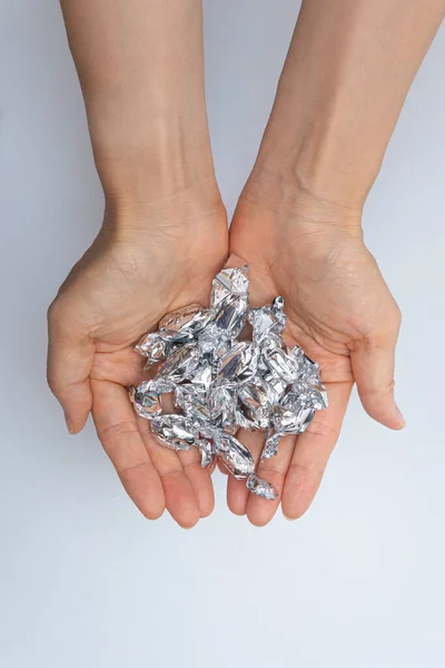 Hands Full Candies Silver Shells — Stockfoto