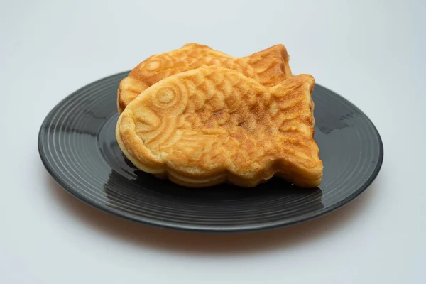 Sweet red bean bread in the shape of a crucian carp in a bowl