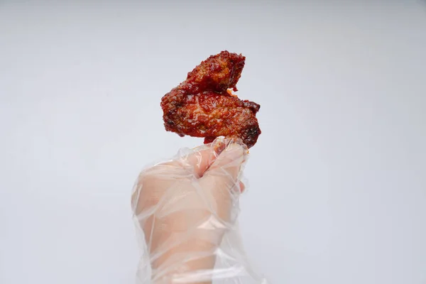 Red and spicy seasoned chicken in a bowl