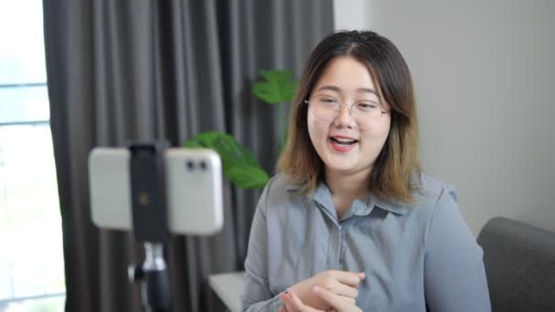 Sonriente Blogger Asiática Sentada Frente Smartphone Con Estabilizador Grabando Video — Vídeo de stock