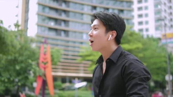 Selbstbewusster Asiatischer Geschäftsmann Mit Drahtlosen Kopfhörern Der Auf Dem Handy — Stockvideo