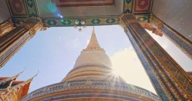 Pagoda of Wat RatchaBophit Buddhist royal temple of Bangkok Thailand looking up with light ray. Beautiful temple travel in Thailand concept.
