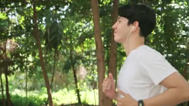 Handsome Asian Man Running Checking Pulse Smartwatch Park Public Green — Stok video