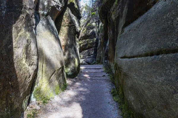 Tourist pathway between rock towers and walls in Adrspach Rocks, Czech Republic.