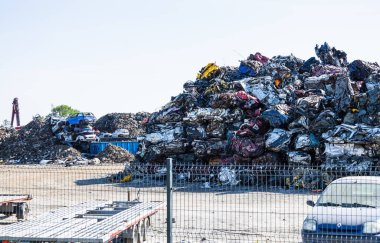 Pile of crushed and deformed cars in the car scrapyard. Oswiecim, Poland, 16 May 2022.