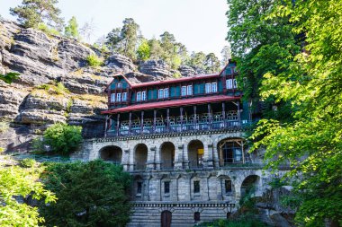 House between rocks near Pravcicka Gate. Hrensko, Czech Republic, 18 May 2022.
