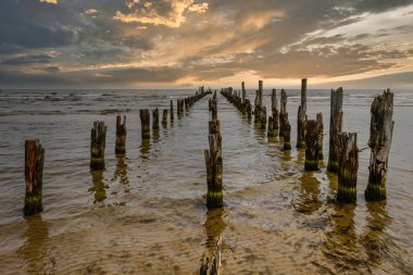 Old abandoned wooden pier or jetty remains on a Baltic sea.
