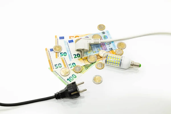 The electric power plugs on Euro banknotes and Euro coins. Concept of the increasing electricity prices.