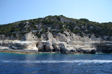 The shore of Paxos island seen from the sea, with a part of the blue caves in the front. clipart