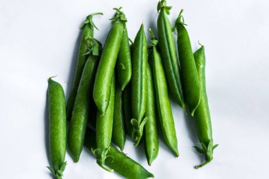 İzole edilmiş beyaz arkaplanda bezelye kabukları.