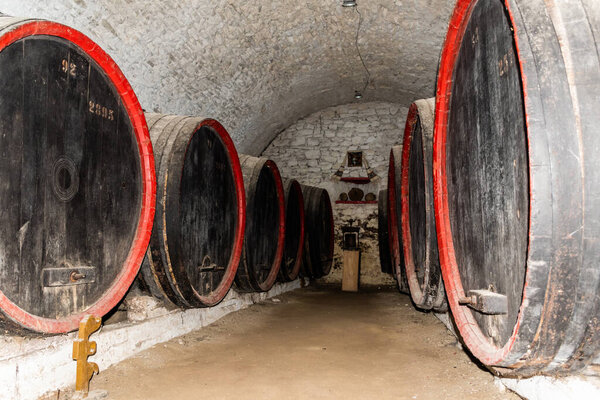 Old barrels in the wine cellar. Calnic fortress, Romania.