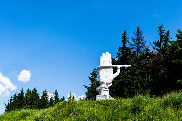 BUCOVINA, ROMANIA - JUNE 20, 2019: The monument of the road workers built by the communist regime, depicting a palm.