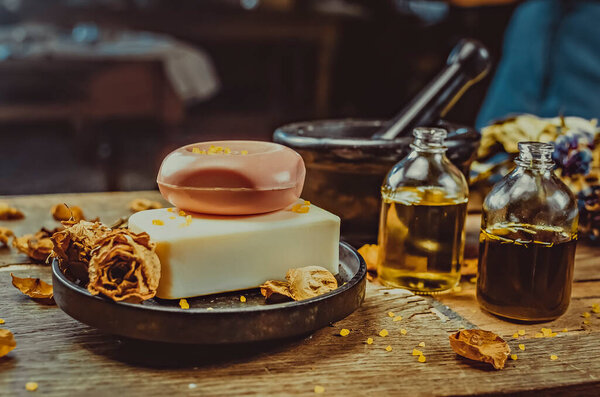 Инсценированное фото на столе. Мыло ручной работы, сухие цветы, декор. коричневый фон из дерева, витражи 