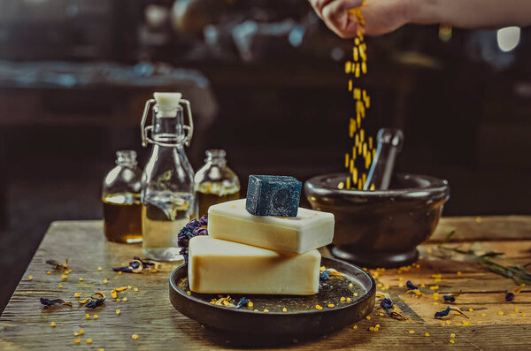 Инсценированное фото на столе. Мыло ручной работы, сухие цветы, декор. коричневый фон из дерева, витражи 