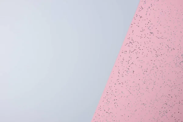 Christmas grey and pink minimal background with confetti. Flat lay, copy space