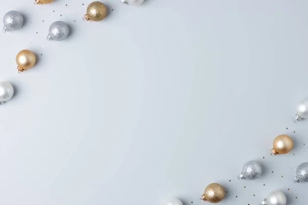 Christmas grey minimal background with grey and beige ball and confetti. Flat lay, copy space