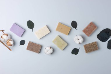 Gri arka planda sabun ve çiçek. Düz yat, boşluğu kopyala.