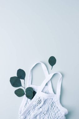 Sıfır atık, sürdürülebilir ve çevre dostu yaşam tarzı. Gri arka planda sepet ve okaliptüs. Düz yat, boşluğu kopyala