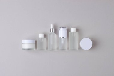 Gri arka planda cilt bakım ürünleri. Düz konum, kompozisyon.