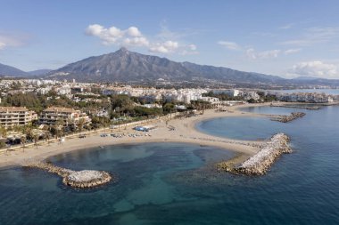 breakwaters of the beach of Nueva Andalusia in Marbella, Spain clipart