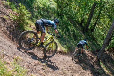 Rovetta Italy 31 July 2022: Cyclists traveling on challenging trails on mountain bikes