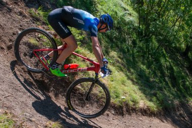 Rovetta Italy 31 July 2022: Cyclists traveling on challenging trails on mountain bikes