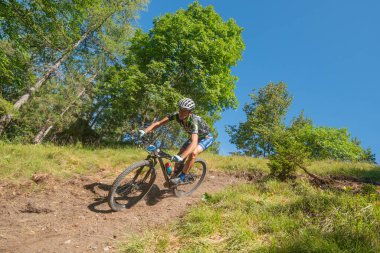 Rovetta Italy 31 July 2022: Cyclists traveling on challenging trails on mountain bikes