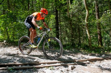 Rovetta Italy 31 July 2022: Cyclists traveling on challenging trails on mountain bikes