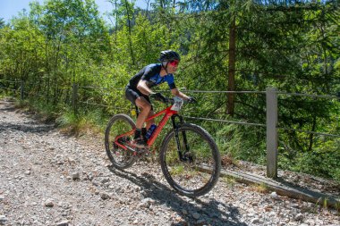 Rovetta Italy 31 July 2022: Cyclists traveling on challenging trails on mountain bikes