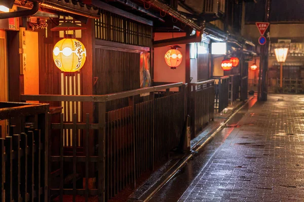 Glowing lanterns in front of small shops at night — Stock Photo, Image