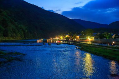 Nehirde mavi saat Dağların arasında Kafe ışıkları kıyıda
