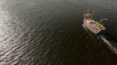 Side view of old sailing ship motoring through open water on sunny day. High quality 4k footage