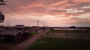 Rise up over country road under dramatic sunset. High quality 4k footage