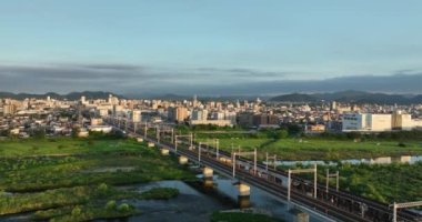 Train approaches Himeji City in early morning. High quality 4k footage