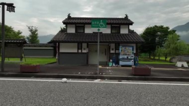 Slow move towards overflowing trash bin next to vending machine at rest stop toliet. High quality 4k footage