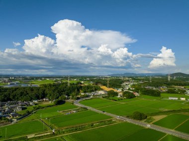 Billowy white clouds over rural farms and landscape on sunny day. High quality photo