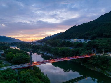 Small suspension bridge across Yoshino River at dawn. High quality photo