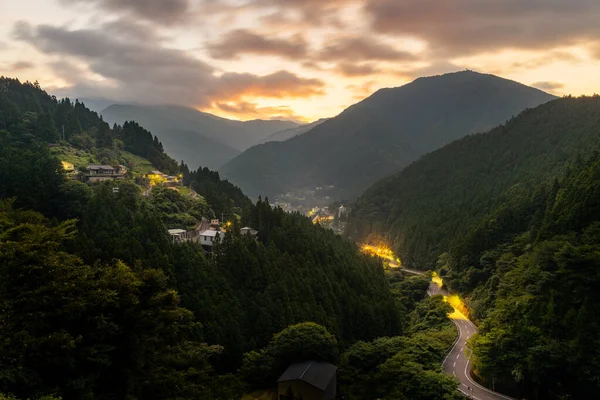 Mountain road winds through Iya Valley village at sunrise. High quality photo