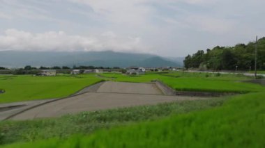 Low slide over terraced rice fields in rural landscape on sunny day. High quality 4k footage