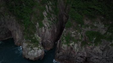 Flyover steep canyon on rugged coast at dawn. High quality 4k footage