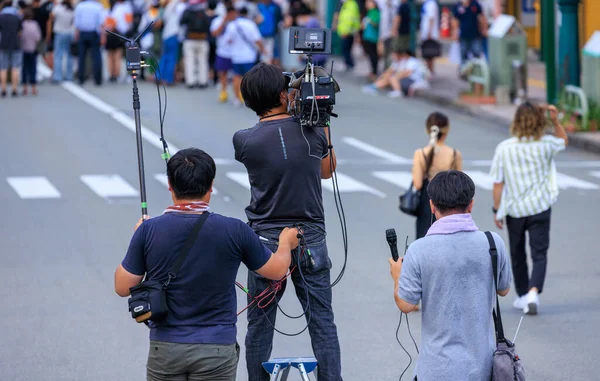Tokushima, Japan - August 12, 2022: Videographer and sound technicians capture content at outdoor event. High quality photo