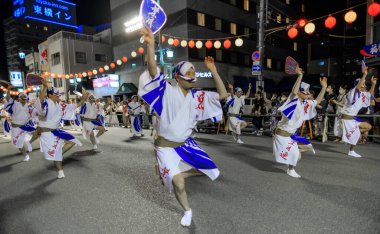 Tokushima, Japan - August 12, 2002: Male dancers perform fan dance at Awaodori street festival. High quality photo